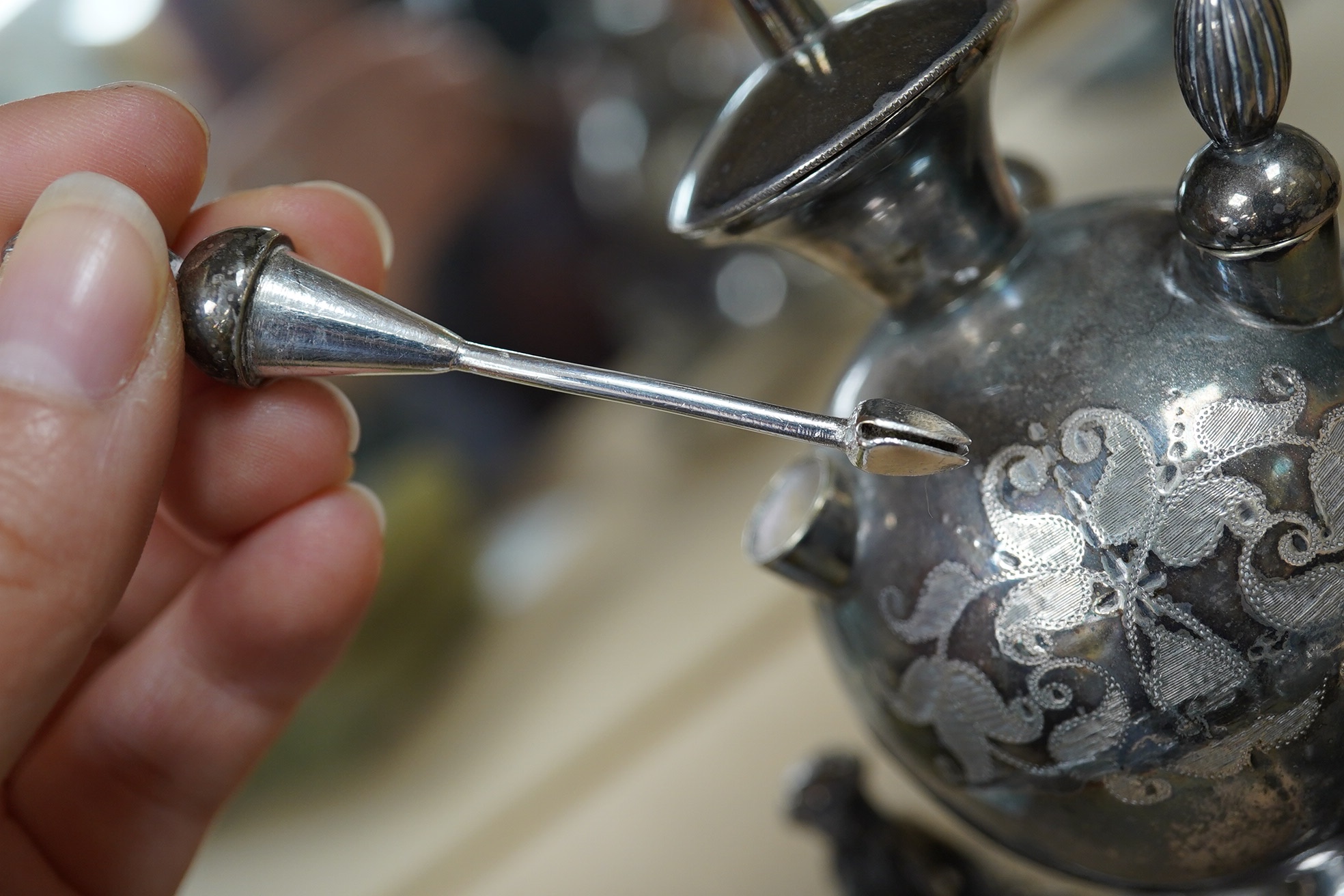 A Victorian plated cigar lamp decorated with seated Persian figures, 14cm high. Condition - fair